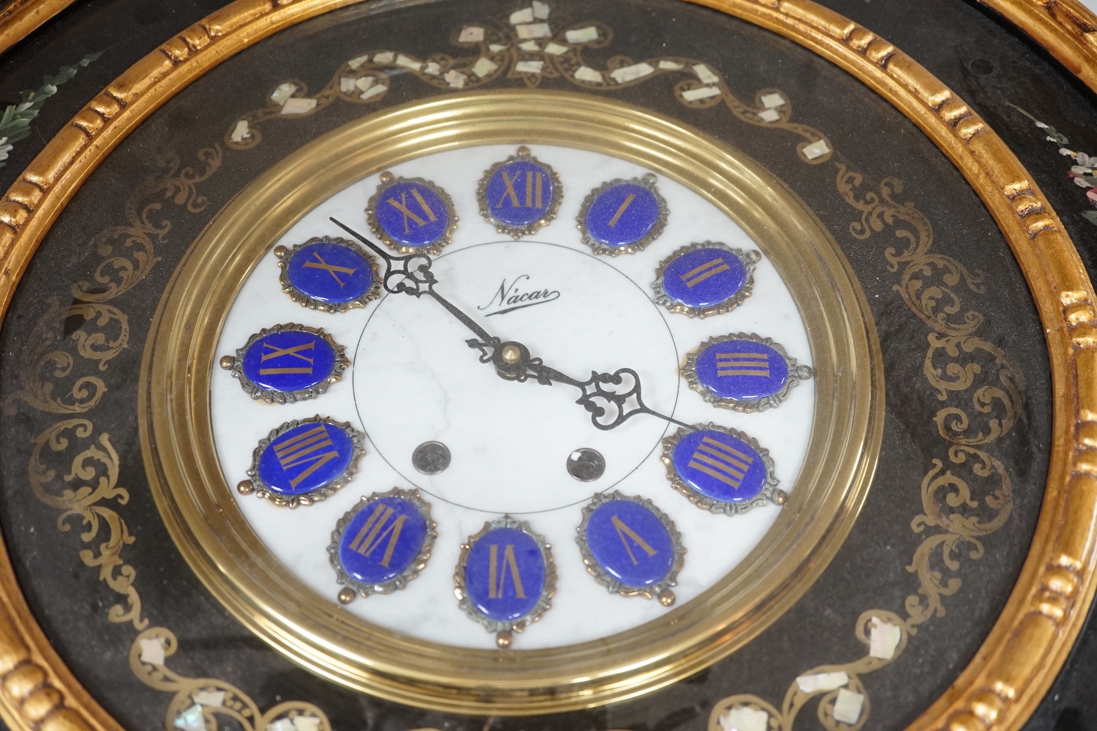 A floral painted clock, length 63cm, quartz movement